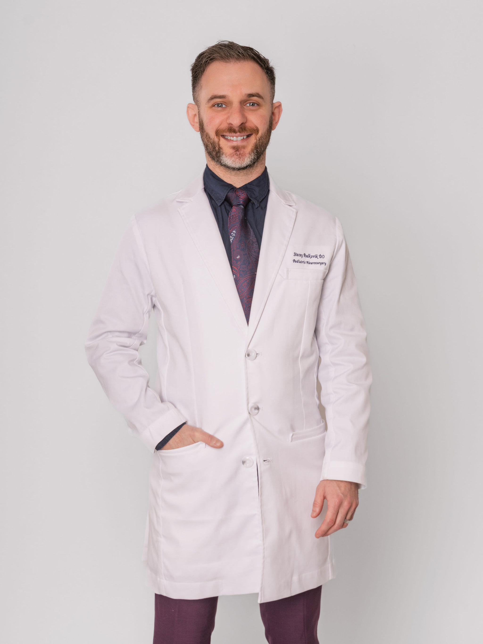 Dr. Stacey Podkovik in a white coat.